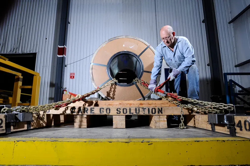 Steel coils supported by the cradle CareGo invented for rail transport