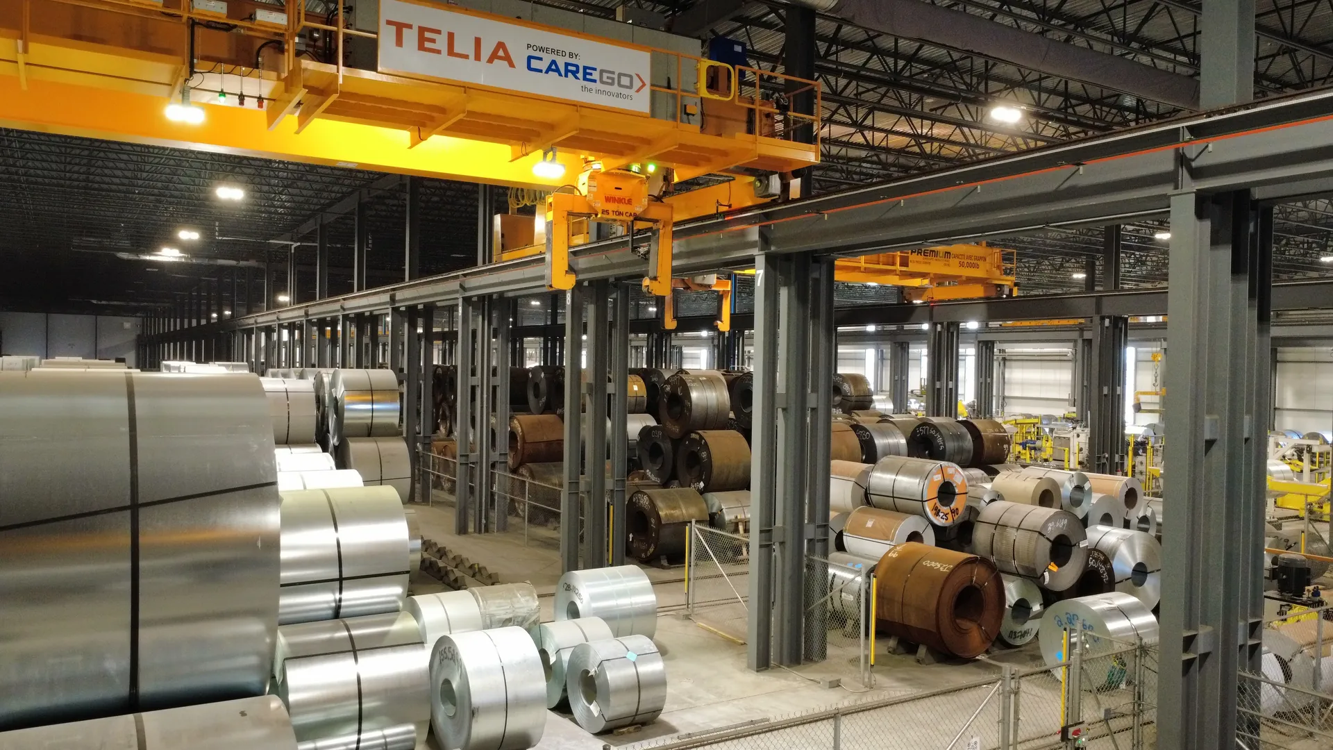 Aerial view looking down the length of a coil storage bay between two production bays