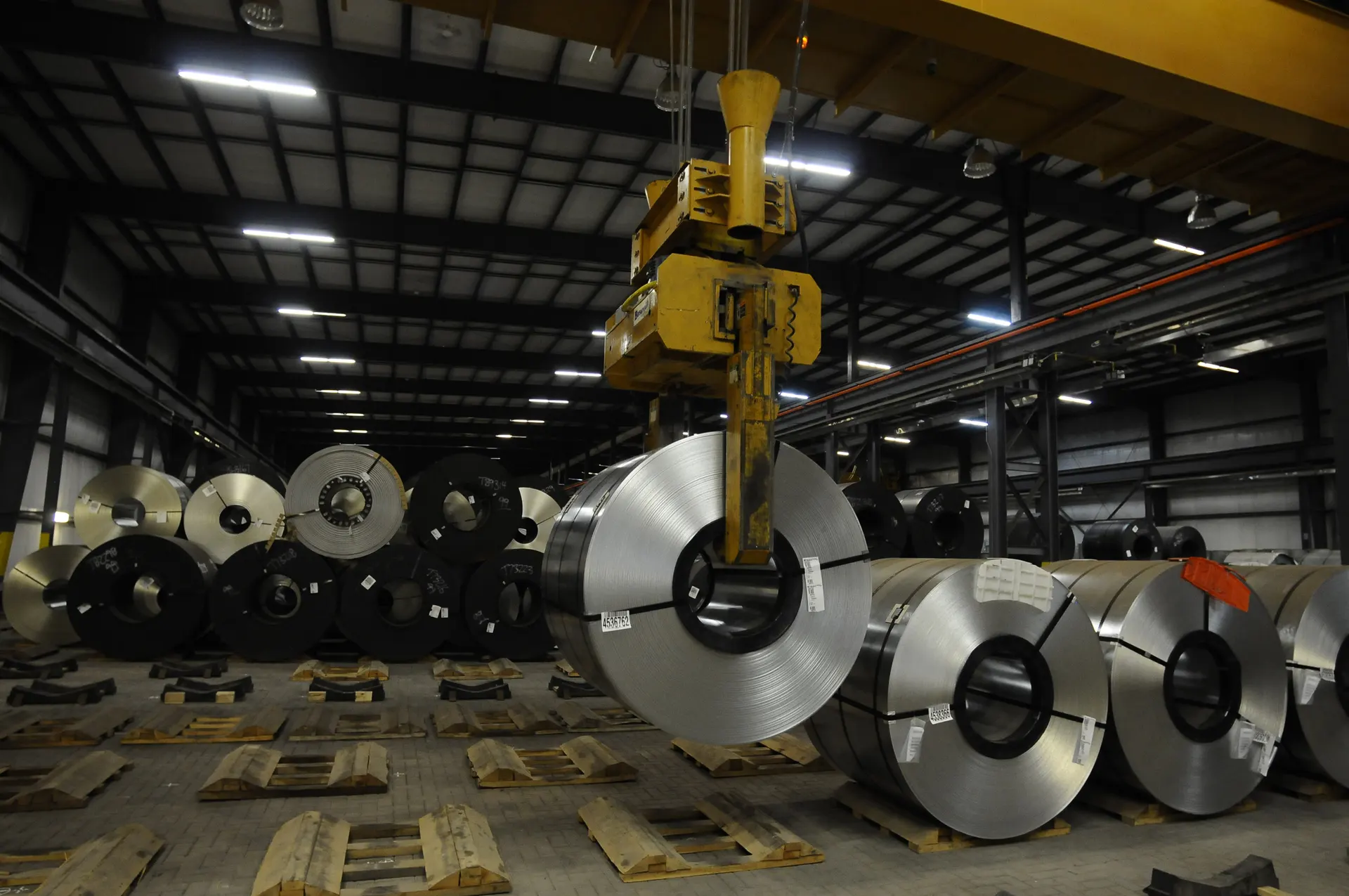 Steel coils in storage under an overhead crane