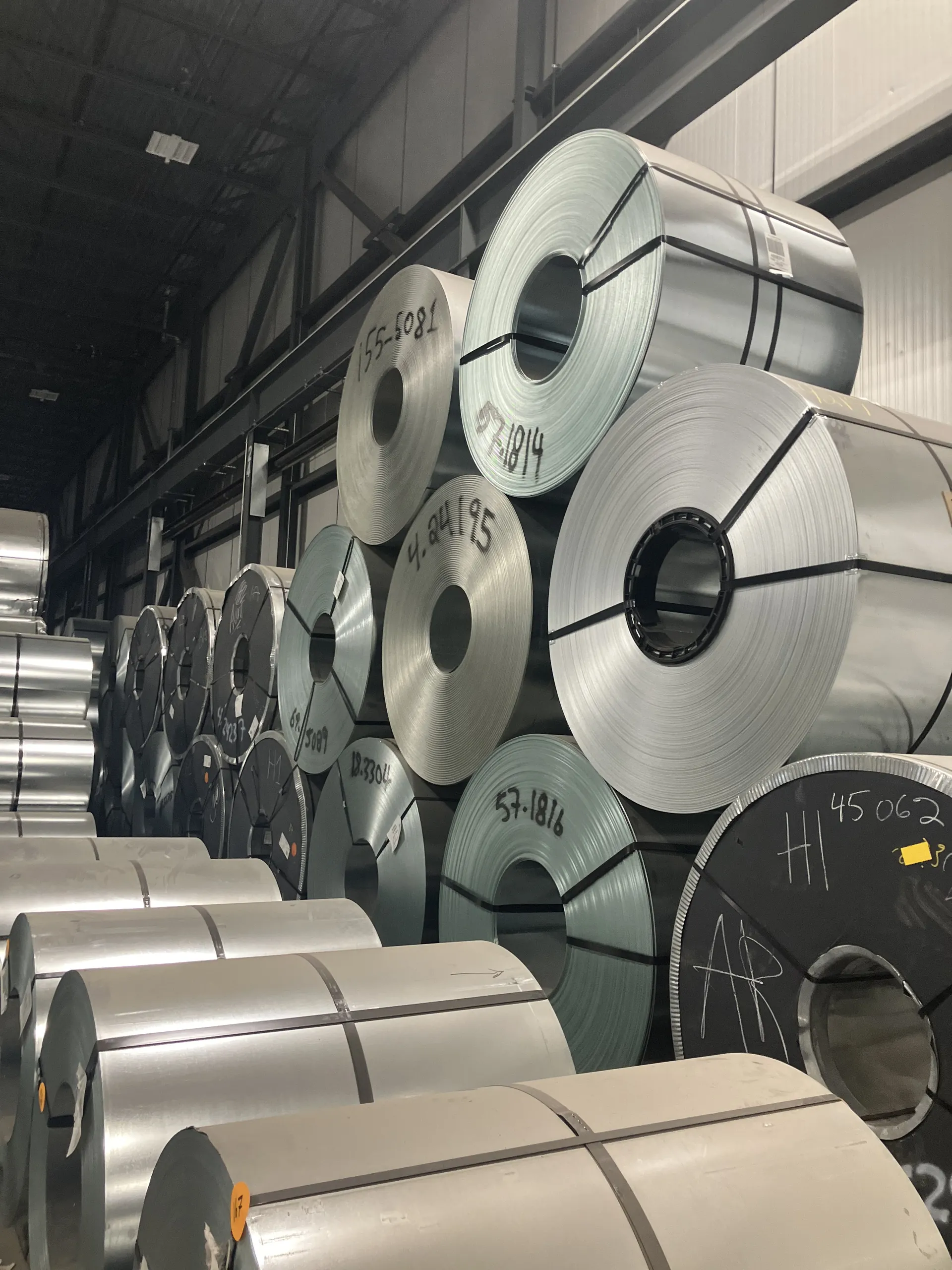 Steel coils stacked three high inside a storage bay